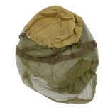 A 1944 dated British army helmet mosquito net