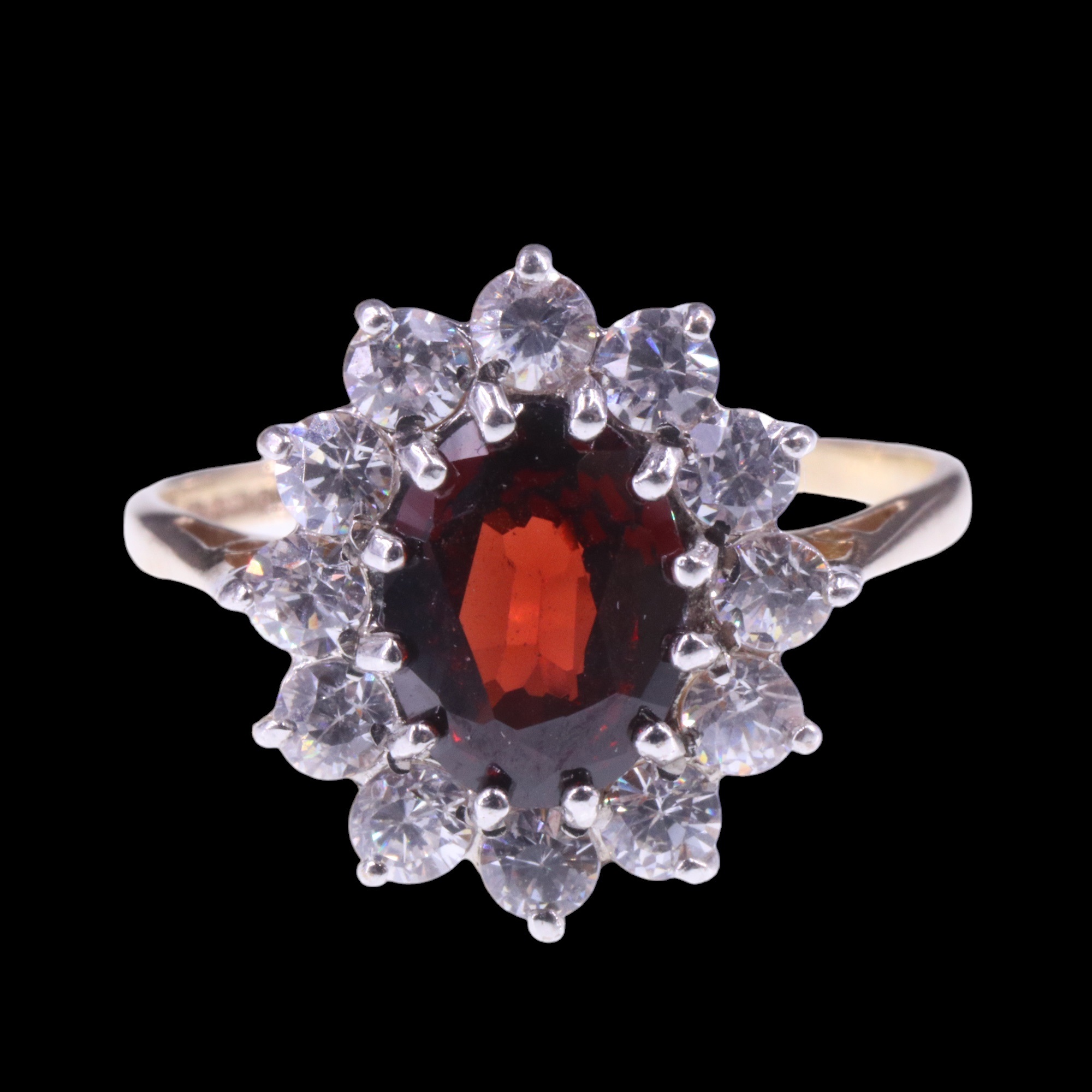 A 1980s garnet and white stone cluster ring, the central oval-cut garnet of approx. 1.4 cts, claw- - Image 2 of 5