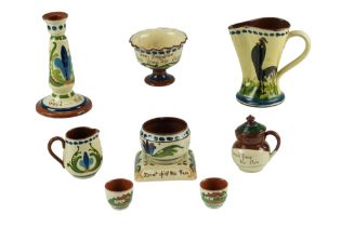 A quantity of Torquay ware including a teapot stand, a candlestick, a jug and a Brampton sugar and