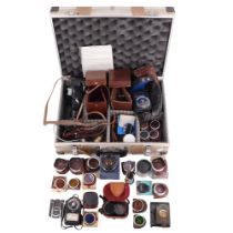 A group of vintage Rollei and other camera accessories including a hard-shell travel case, light