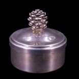 A 2001 silver pill or similar box, of drum form, its ogee domed slip lid having a pine cone shaped