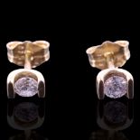 A pair of diamond ear studs, the brilliant-cut diamonds of approx 0.2 cts aggregate weight, bar-