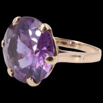 An amethyst finger ring, the 14 mm round stone claw set on a pierced gallery between open tapering