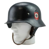 A post-War steel helmet bearing spurious German insignia