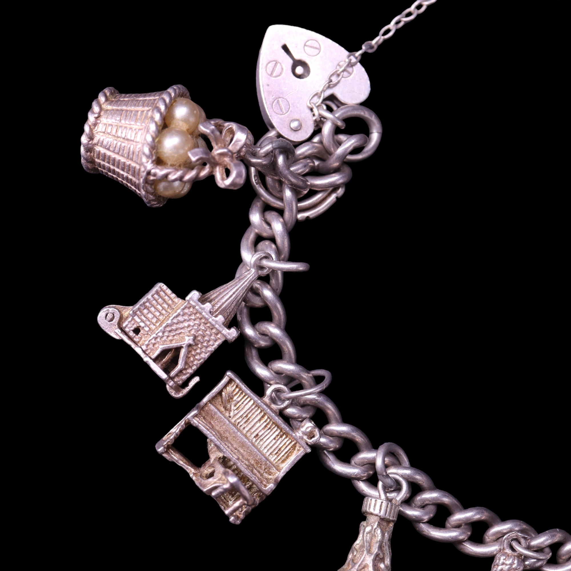 A vintage silver charm bracelet including spaceman and ship in a bottle charms, 47 g - Image 3 of 4