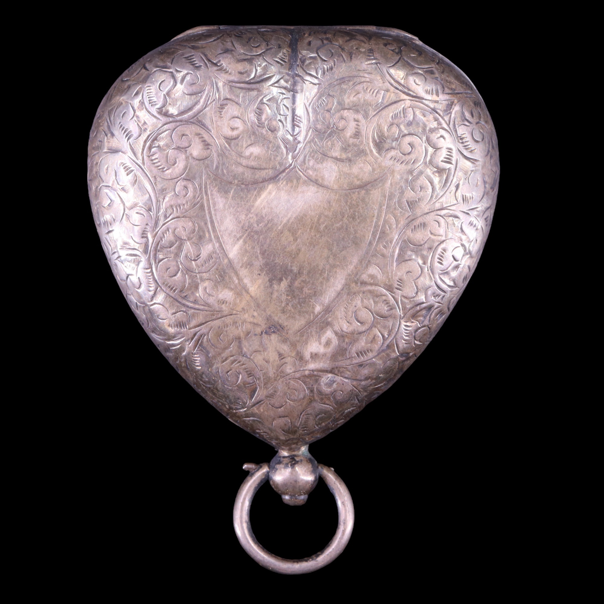 A late Victorian silver heart-shaped sovereign and stamp purse, foliate scroll engraved and faced by