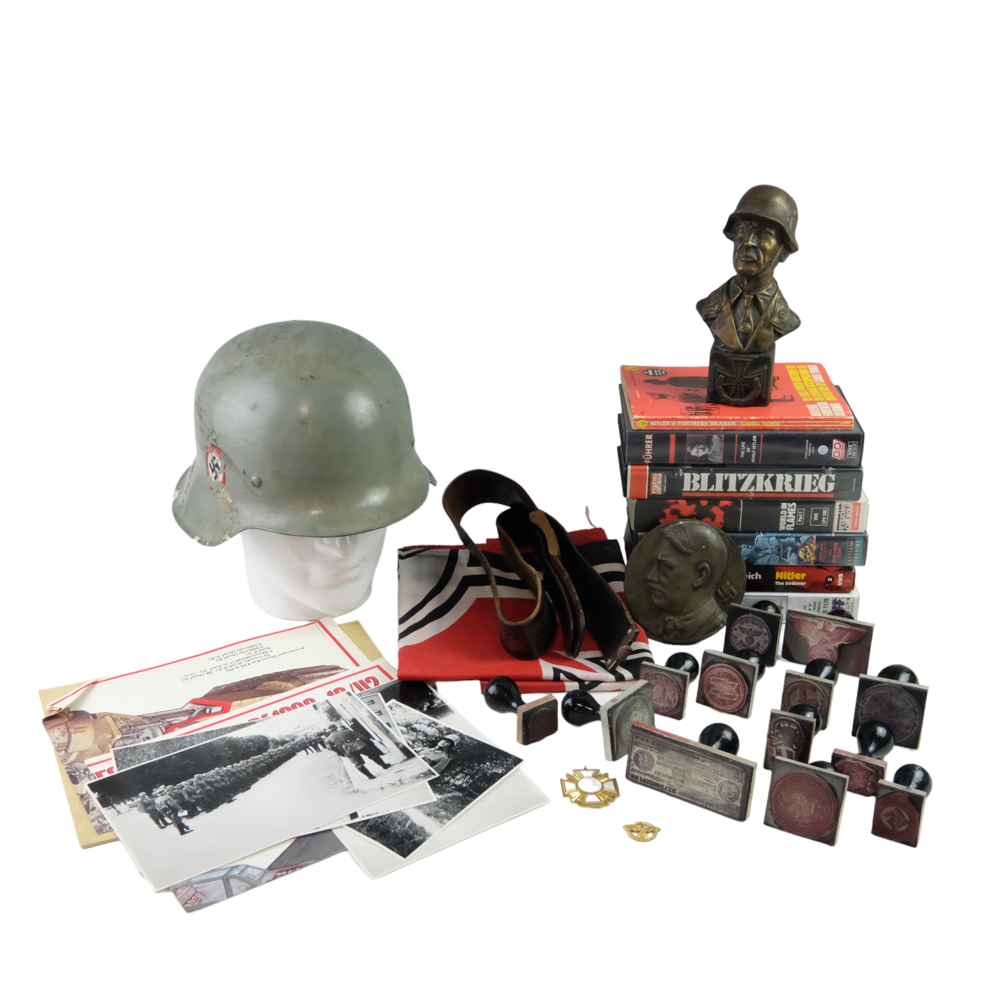 A quantity of late 20th Century books, video cassettes, ink stamps, a helmet, flag etc pertaining to