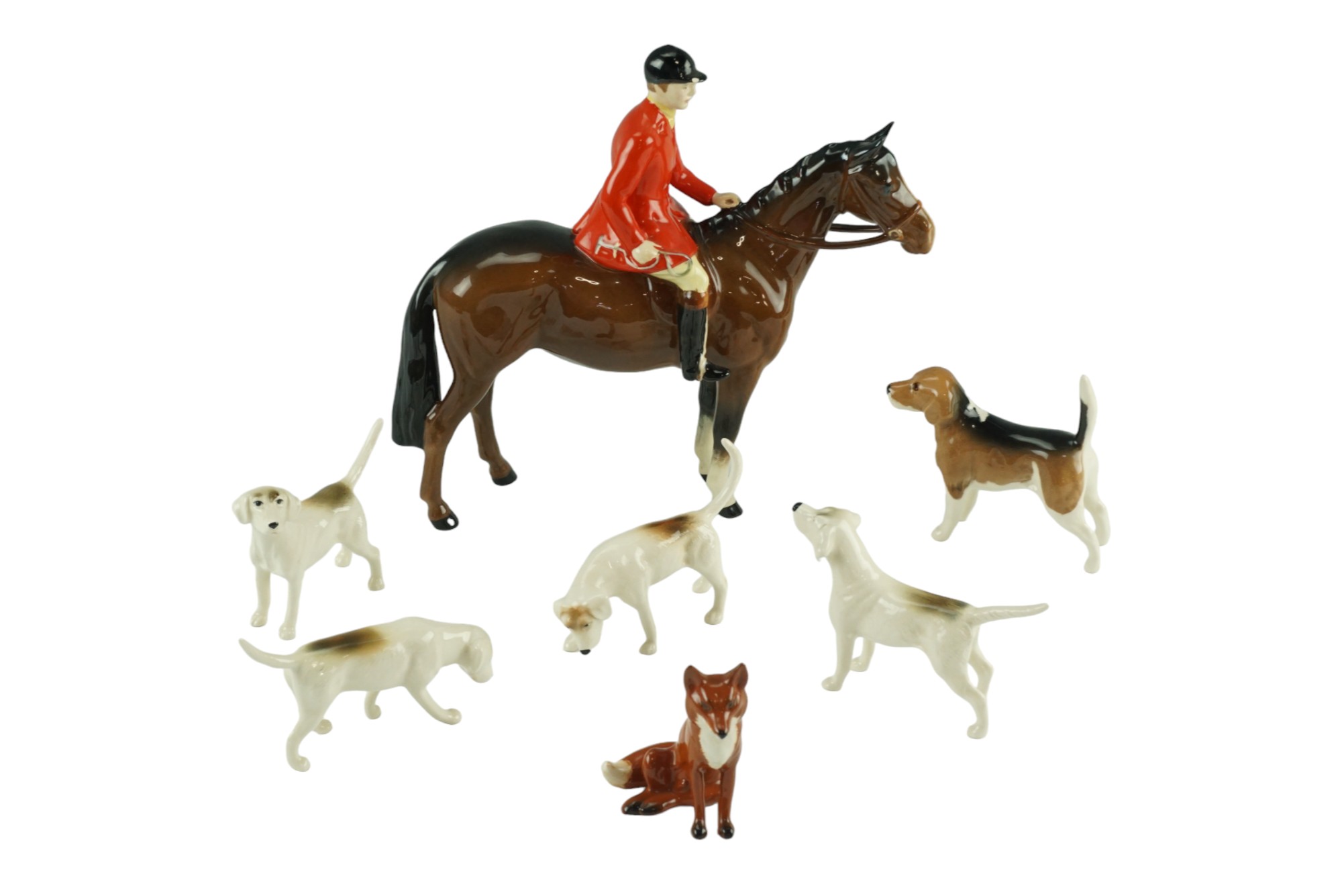 A Beswick "The Huntsman" figurine together with hounds and a fox, former 21 cm (small chip to hat