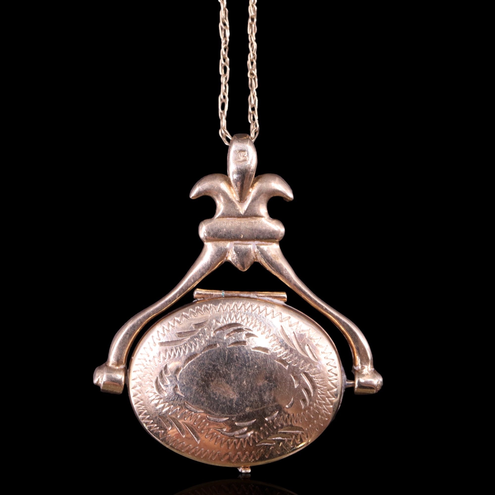 A 9 ct gold double locket in the form of an antique swivel fob seal, on a fine link neck chain, 33