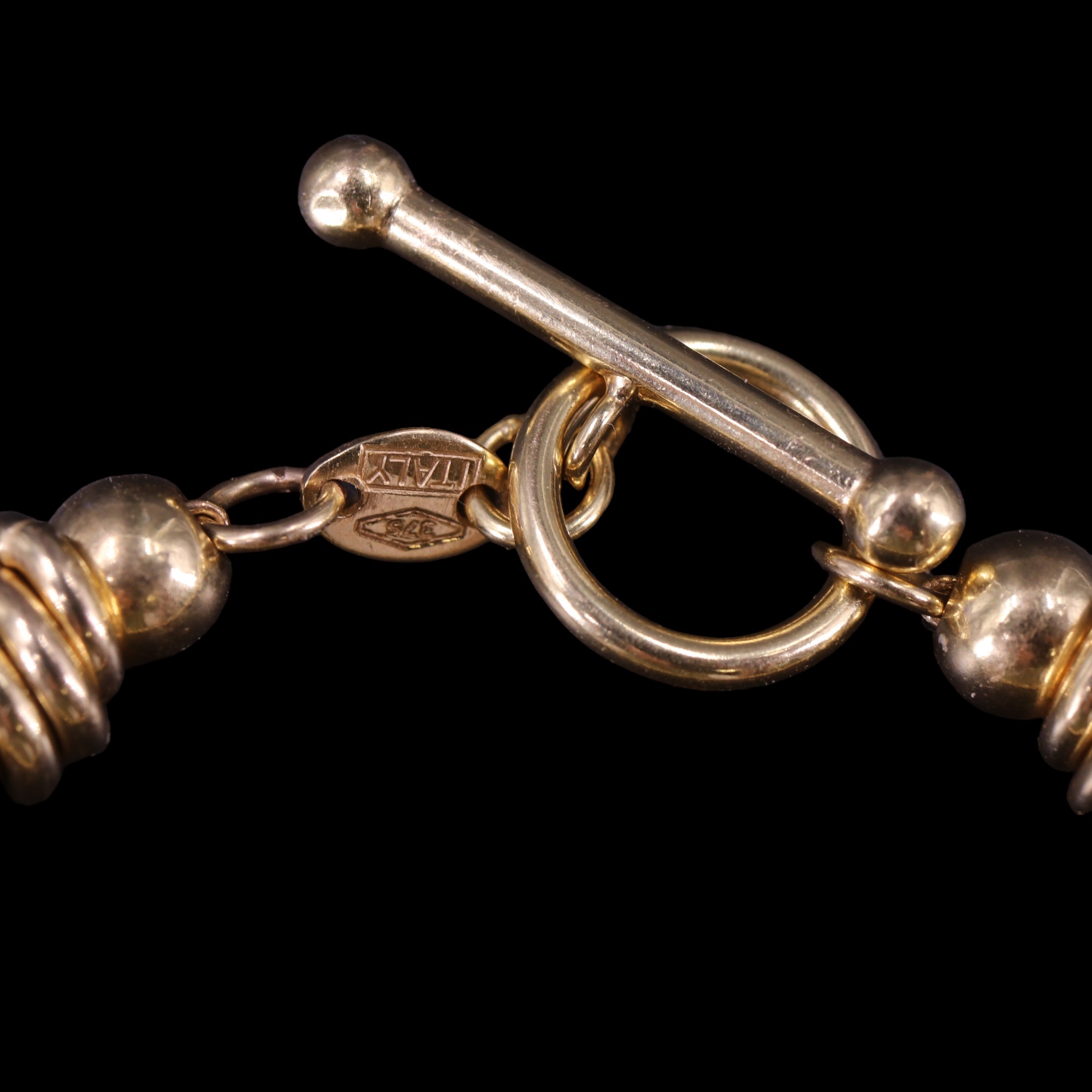 A bracelet of 9 ct gold rings on a fine belcher-link chain with T-bar and ring clasp, 19.5 cm, 8.7 - Image 2 of 3