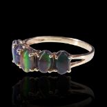 A five-stone ammolite ring, comprising five variously coloured cabochons claw-set between the