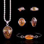 A collection of white metal mounted sun-spangled amber jewellery including a large asymmetric