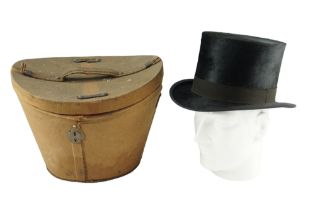 An early 20th Century silk top hat in buckram-covered case, internal circumference 55 cm