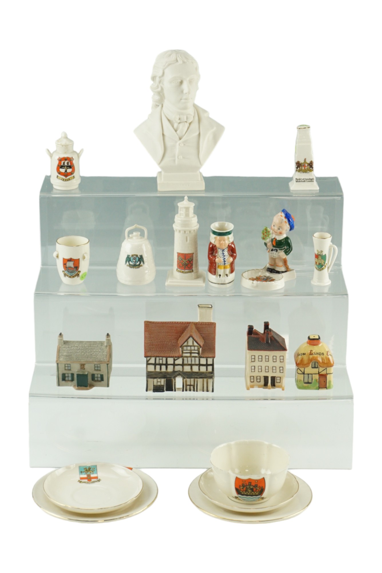 A large group of W H Goss crested china including a Hancock bust, a salt shaker and a Toby jug, bust