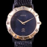 A Gucci gilt and black quartz dress wristwatch, 33 mm, (un-tested)