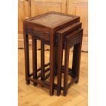 A Chinese carved hardwood nest of table, having burr-wood tops, 40 cm x 32 cm x 62 cm