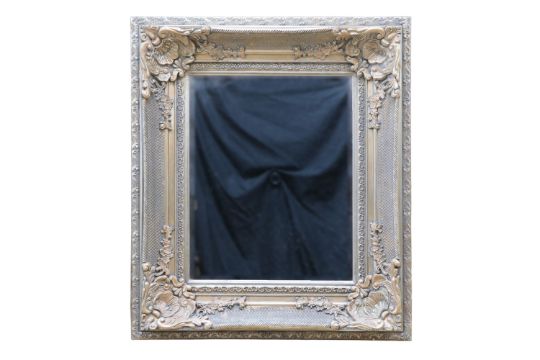 A large contemporary wall mirror having a decorative moulded frame, 92 cm x 106 cm