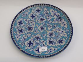 Late 19th / early 20th Century Iznik style pottery charger with floral decoration on a pale blue