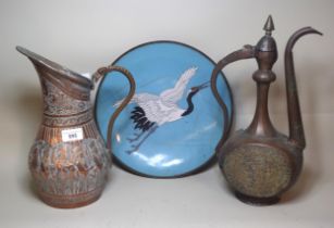 Two Middle Eastern copper jugs together with a cloisonne dish decorated with a crane in flight, 30cm