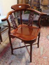 Mid 20th Century Chinese carved hardwood corner chair with a panel seat on shaped supports with