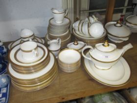 An extensive Royal Doulton ' Royal Gold ' dinner and tea service comprising: ten 27cm plates, ten