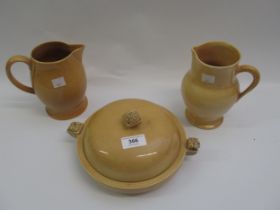 Ashtead potters oatmeal muffin dish with cover together with two jugs The butter dish has one of its