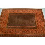 Machine woven Persian design carpet with a rectangular centre panel and dark ground with wide floral