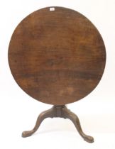 18th Century mahogany circular pedestal table, the one piece figured tilt top above a vase turned