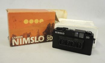 Nimslo 3D 35mm camera with original box Does crank and shoot, some spots of rust but generally in