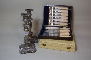 Pair of silver plated candlesticks and two cased sets of plated flatware