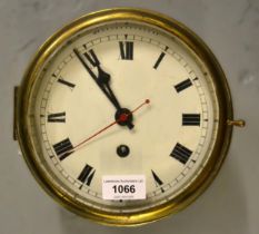 Circular brass ships clock, the enamel dial with Roman numerals and a single train movement , the