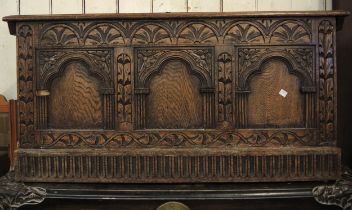 Early to mid 20th Century carved oak coffer with a three panel front, 105cm wide