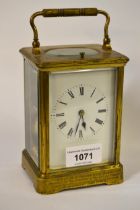 Early 20th Century brass cased carriage clock, the enamel dial with Roman numerals, the two train