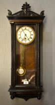 Late 19th / early 20th Century walnut and ebonised Vienna style wall clock, the enamel dial with
