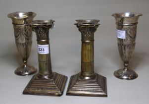 Pair of Chester silver Corinthian column dwarf candlesticks, together with a pair of London silver