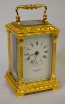 Small gilt brass cased carriage clock with enamel dial and Roman numerals, signed Taylor & Bligh,