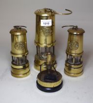 Three various small brass miner's lamps, together with a colliery trophy ' Senghenyddin '