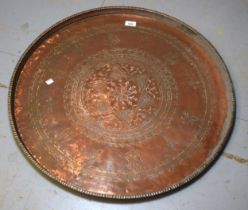 Large Indian circular copper tray with engraved decoration, 70cm diameter