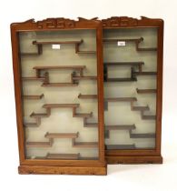 Pair of modern Chinese hardwood wall mounted display cabinets, each with a single glazed panel