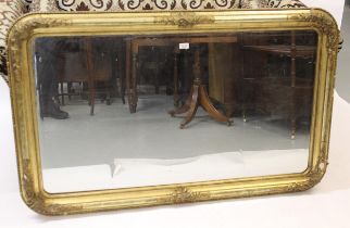 19th Century gilded composition rectangular wall mirror, the moulded frame with relief floral