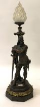 Late 19th / early 20th Century bronze lamp base in the form of a standing warrior, the frosted glass