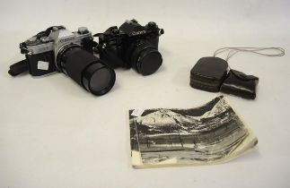 Canon AE1 35mm camera, together with a Canon A1 35mm camera and a small quantity of accessories