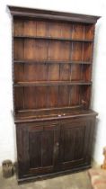 Early 20th Century stained pine dresser with a boarded shelf back above two rectangular panel doors,