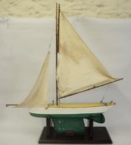 Small wooden model pond yacht on a stand with rigging