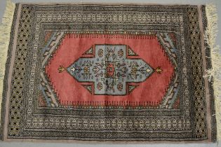 Pakistan rug of Persian design with a single medallion on a rose ground with borders, 116 x 80cm