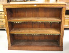 Edwardian walnut and inlaid open bookcase, the moulded top above a decorative frieze and