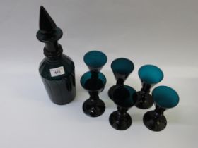 Early 19th Century green tinted glass decanter with stopper, together with a set of six green tinted