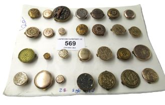 Card containing a collection of twenty eight bachelor buttons in brass and gold plate