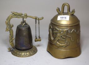 Chinese brass bell with dragon decoration, together with another on a stand and chime