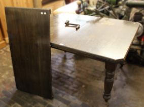 Small Edwardian rectangular wind-out extending dining table with a single extra leaf, together
